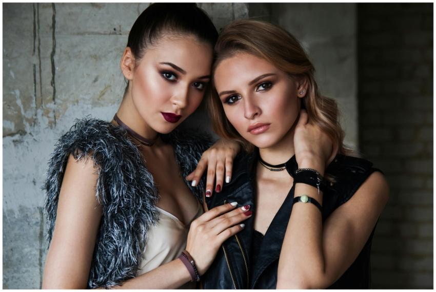 Elegant portrait of two fashionable women showcasi