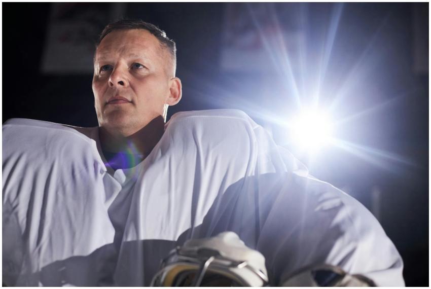 A focused ice hockey player in professional gear u