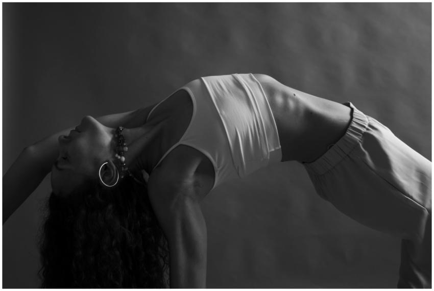 Monochrome image of a woman practicing yoga in a s