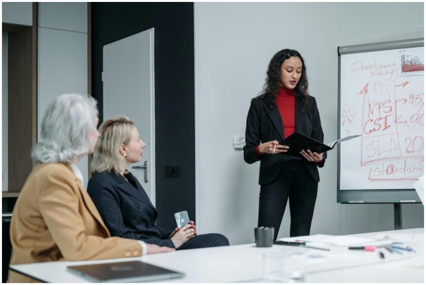 Three business women in a modern office holding a