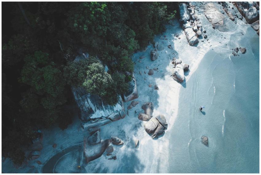Aerial shot of a rocky beach with turquoise water