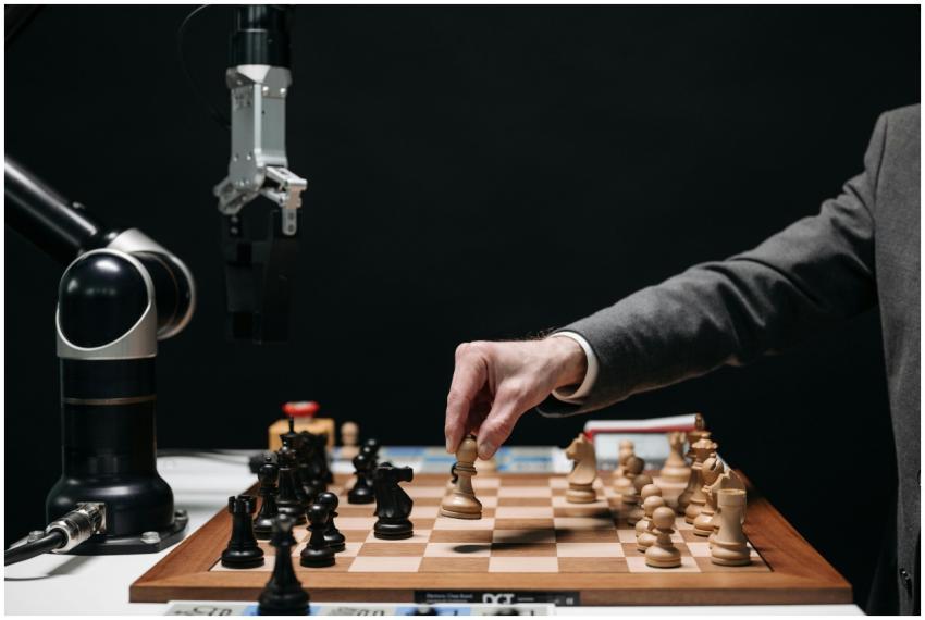 A robotic arm plays chess against a human, symboli