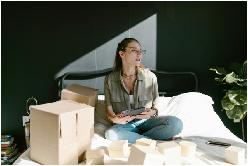 Woman working on e-commerce startup with tablet an