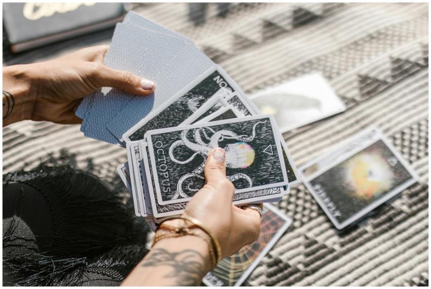 Hands holding tarot cards during a reading session
