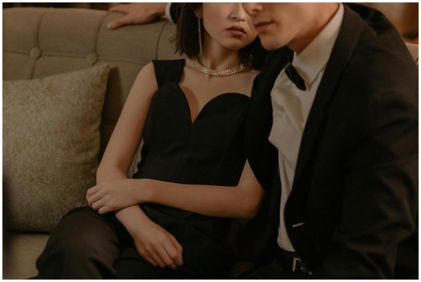 An elegant couple in formal attire portrays sophis