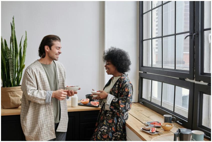 A happy couple shares a light breakfast by the win