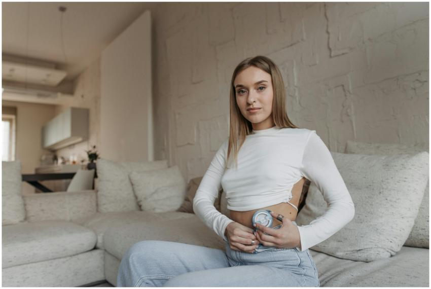 Young woman sitting on a couch managing diabetes w