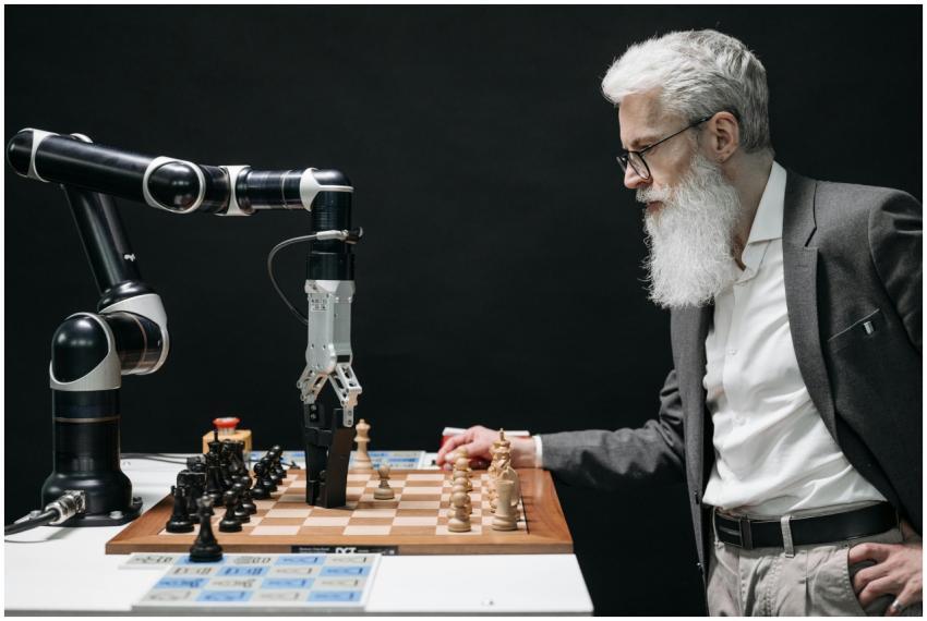 A man plays chess against an AI robotic arm, showc