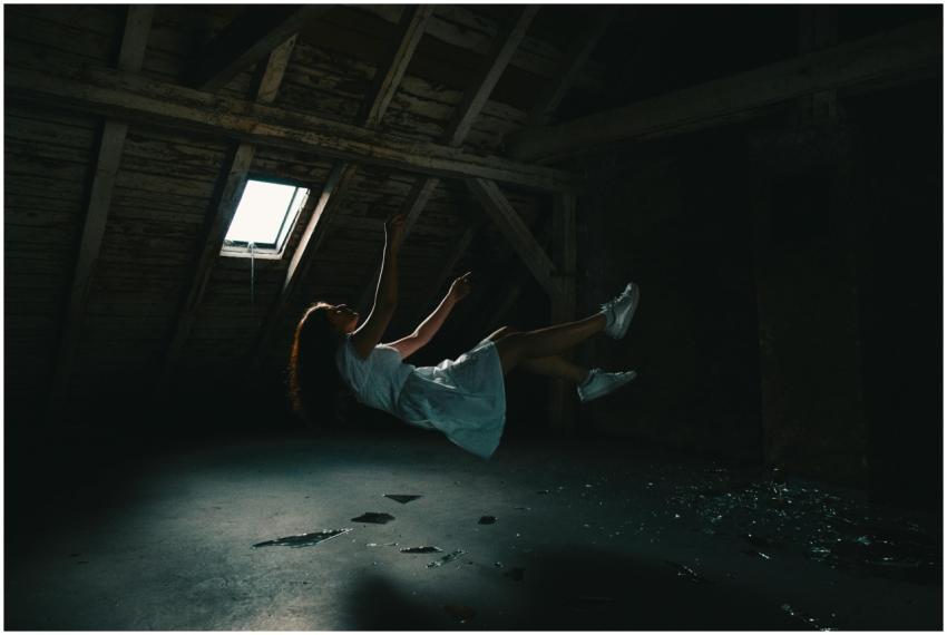 A surreal photograph of a woman in a white dress f