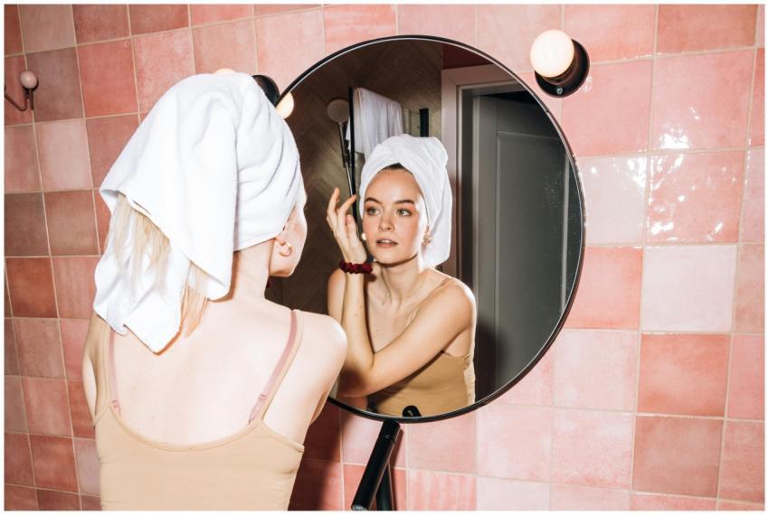 A young woman with a towel in a pink bathroom, ref
