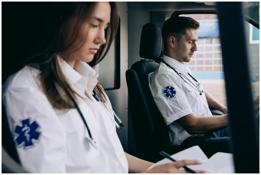 Two professional paramedics in uniform inside an a