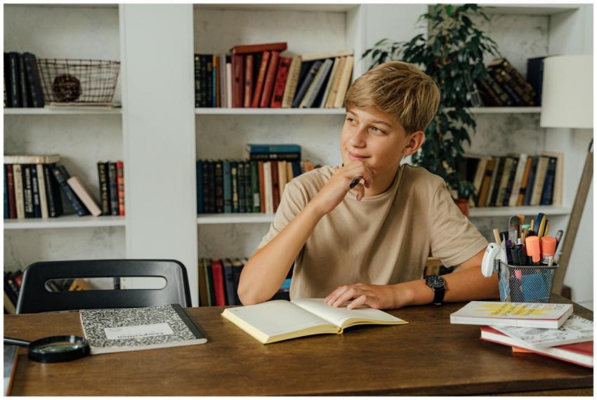 A thoughtful teenager pondering at a study desk su
