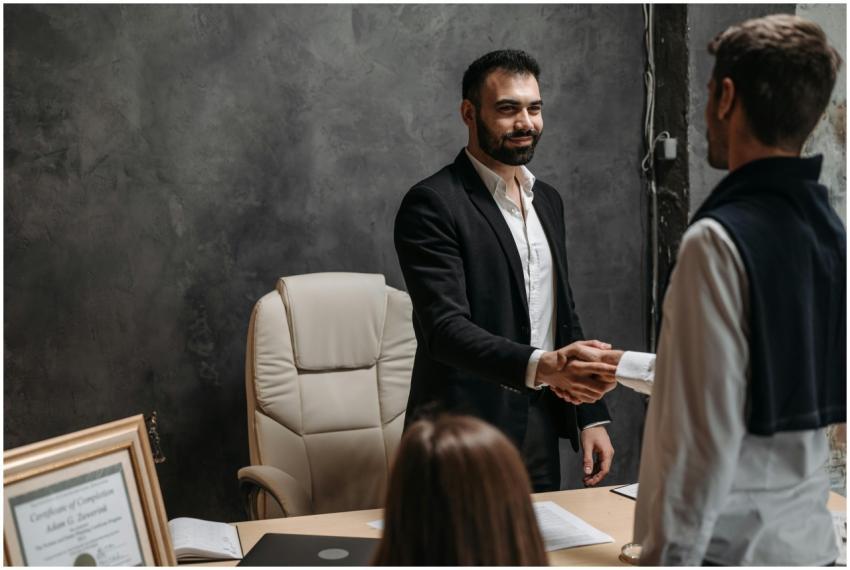 Businessmen in suits shaking hands in a profession