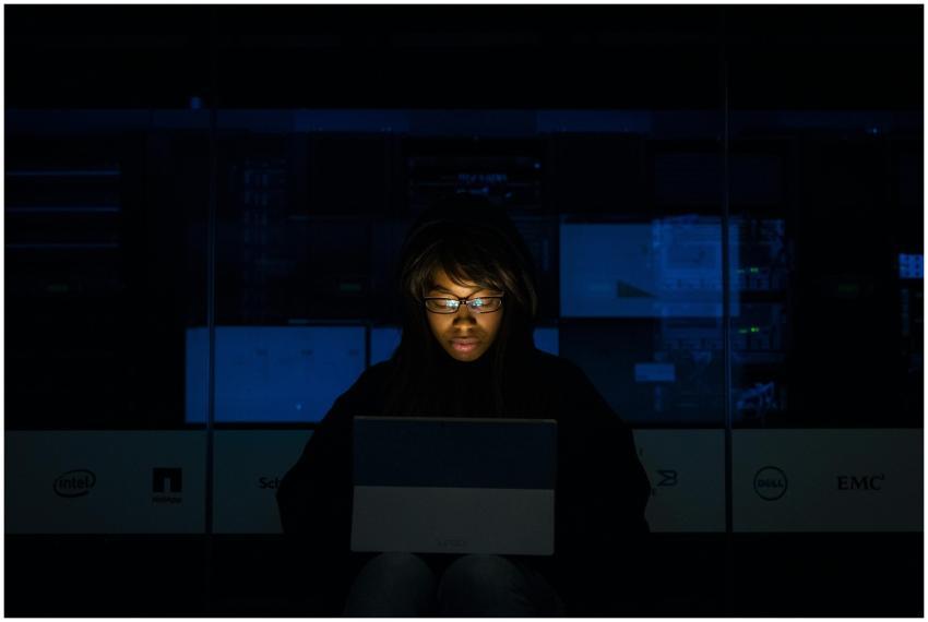 A woman deeply engrossed in programming on a lapto