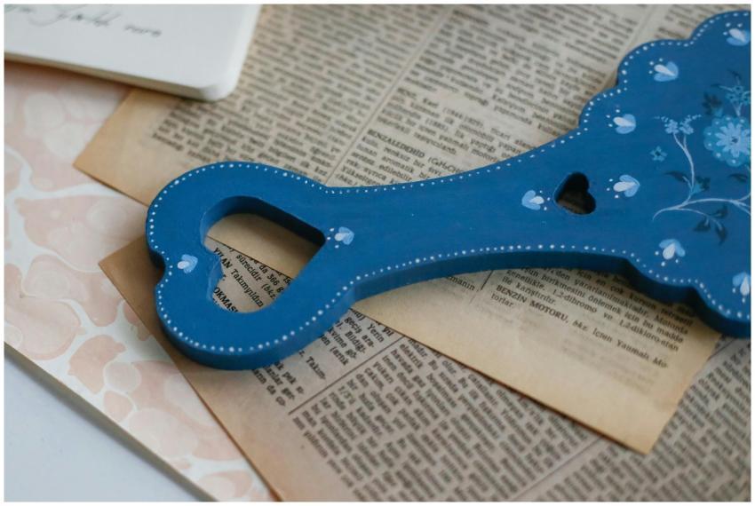 A flat lay of a decorative blue floral wooden hand