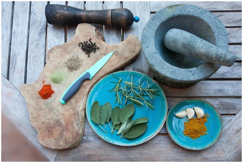 A rustic setup for spice preparation with herbs, s