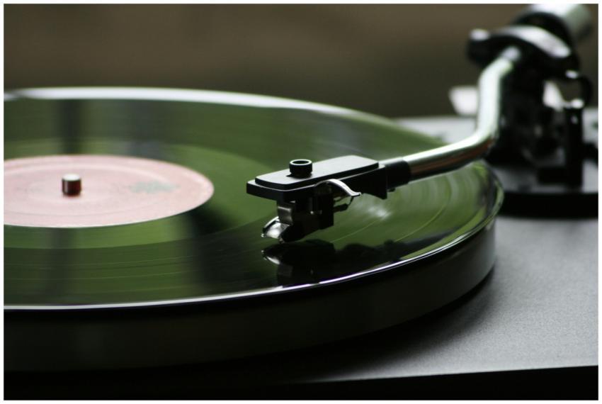 A close-up view of a rotating vinyl record on a vi