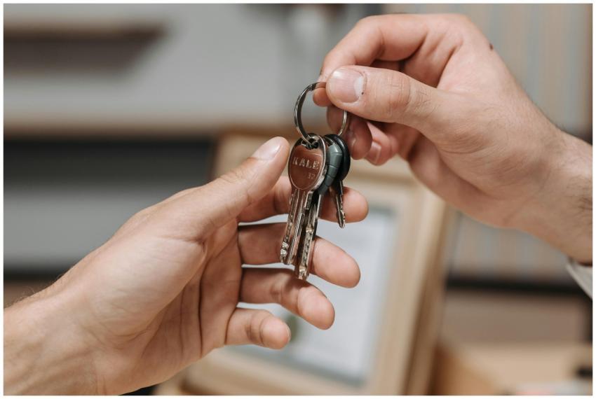 A close-up image of two hands exchanging a set of
