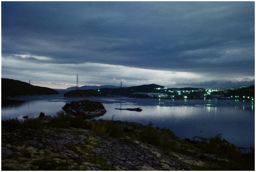 Serene evening landscape with calm waters, distant
