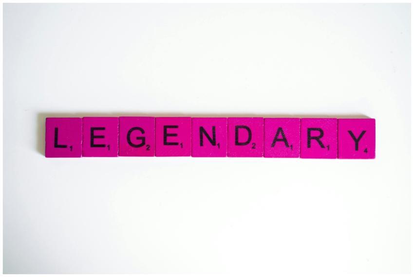 Pink Scrabble tiles spelling 'Legendary' on a whit