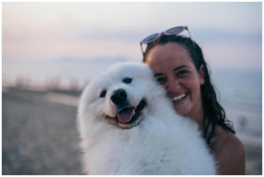 A joyful scene of a woman with sunglasses holding