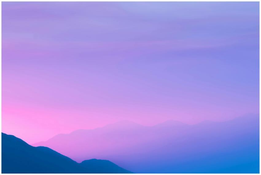 A beautiful silhouette of mountains against a grad