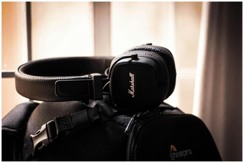 Close-up of black headphones placed on a travel ba