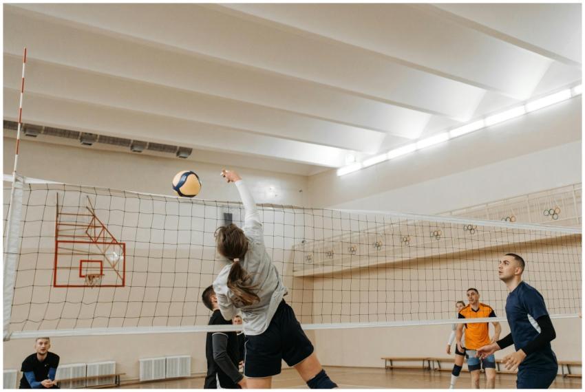 Players engaging in a competitive indoor volleybal