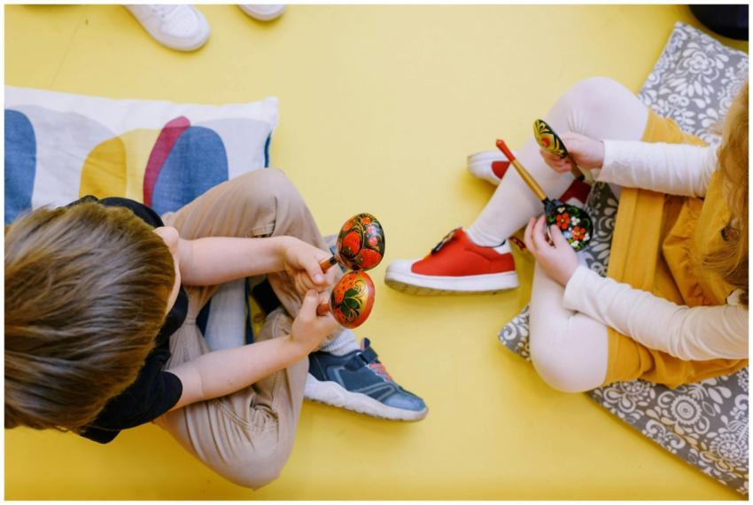Joyful children playing maracas in a colorful pres