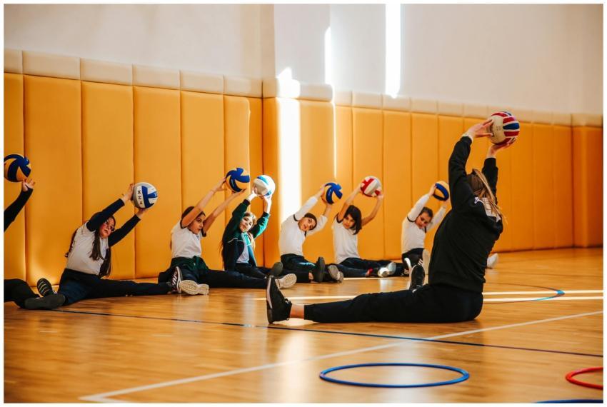 Group of children practicing volleyball stretches