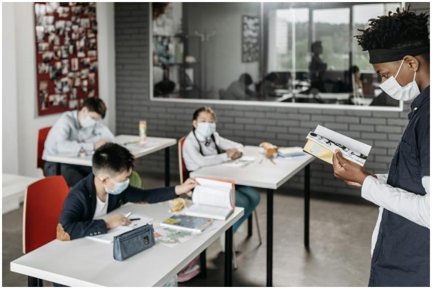 Students wearing masks in a classroom setting duri