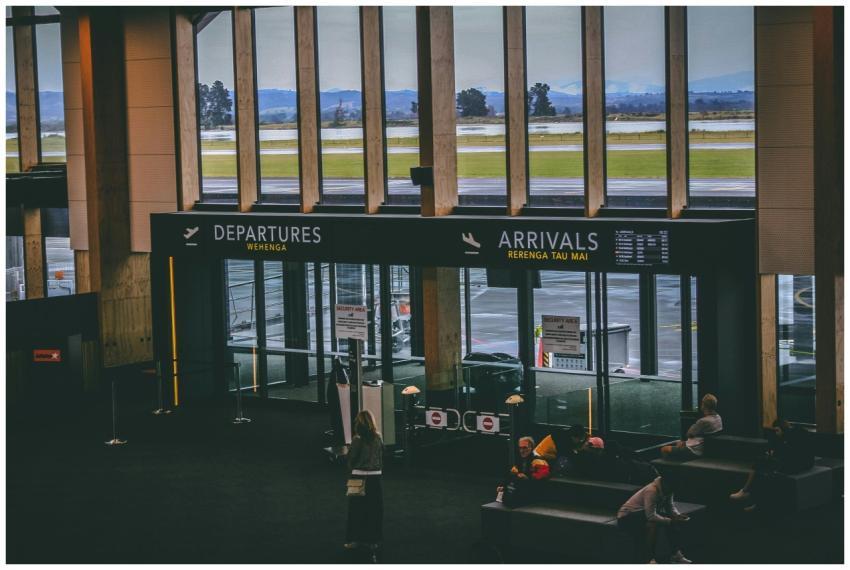 Busy airport terminal area with people, featuring