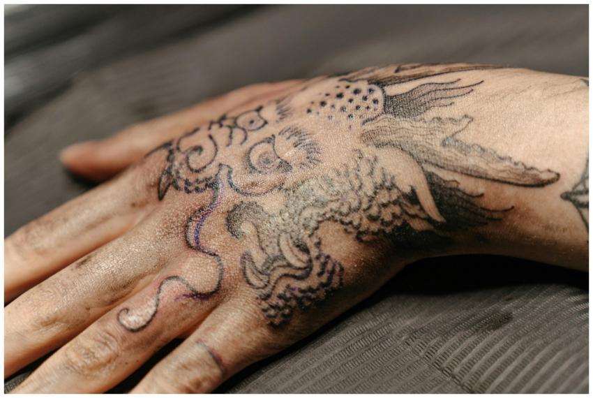 Close-up view of a detailed hand tattoo featuring
