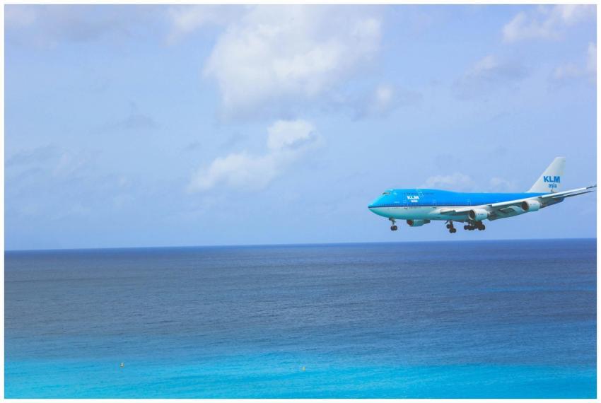 KLM Boeing 747 in flight over a stunning blue ocea