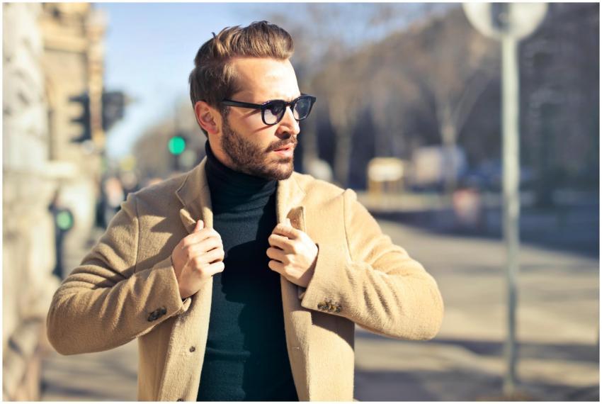Fashionable young man with sunglasses poses outdoo
