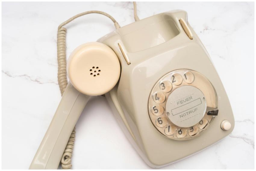 Classic beige rotary telephone with dial plate, em