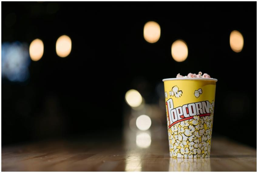 Close-up of popcorn in a yellow cup on a wooden ta