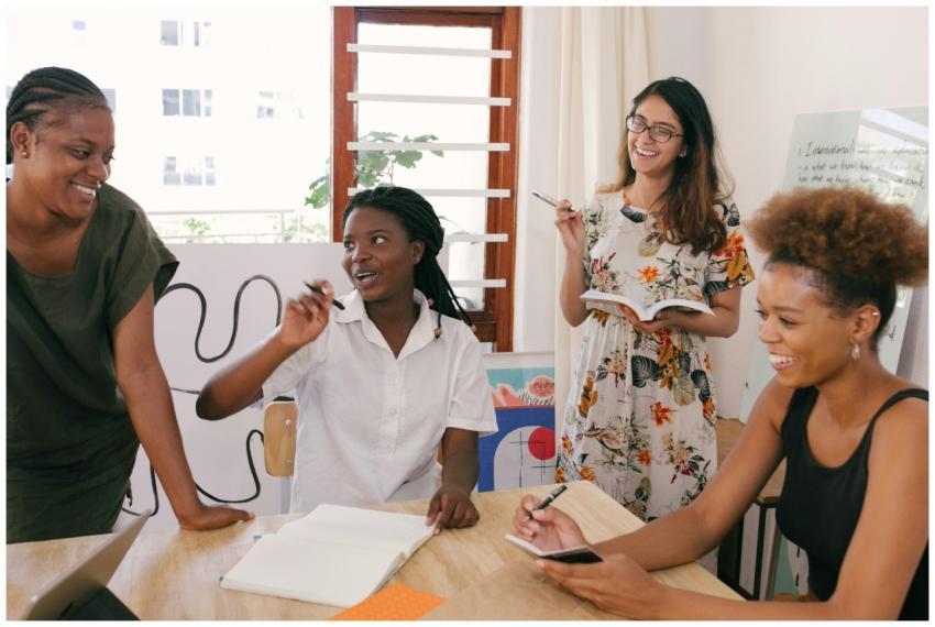A diverse group of women engaged in a lively offic