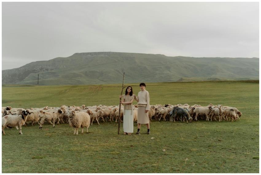 Two shepherds with a flock of sheep in a vast coun