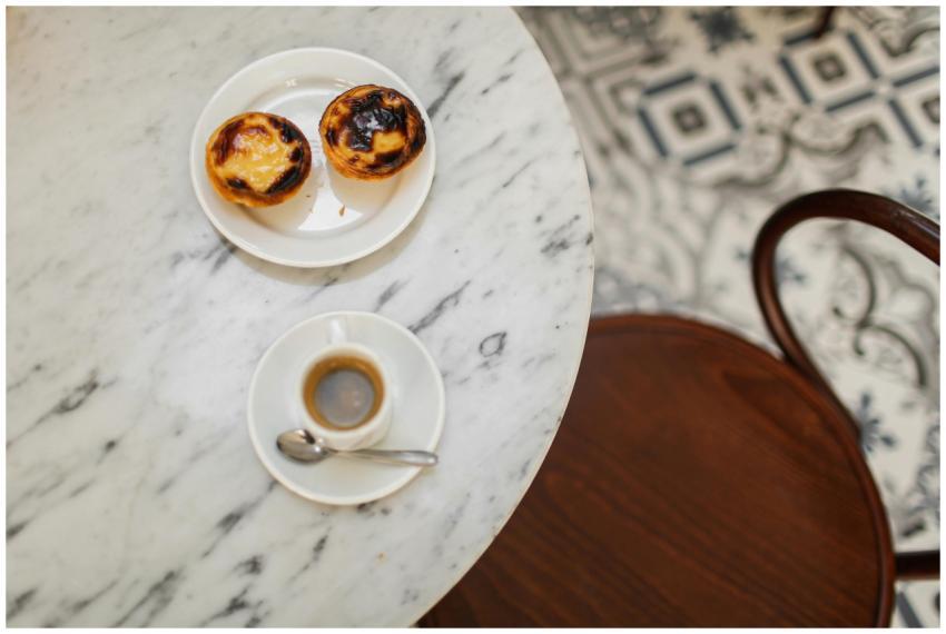 Top view of pastries and espresso on a marble tabl