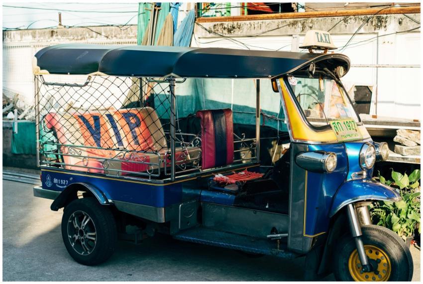 Colorful tuk tuk taxi parked on a bustling street