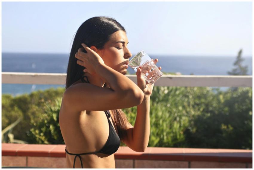Woman in swimwear enjoying a refreshing drink with