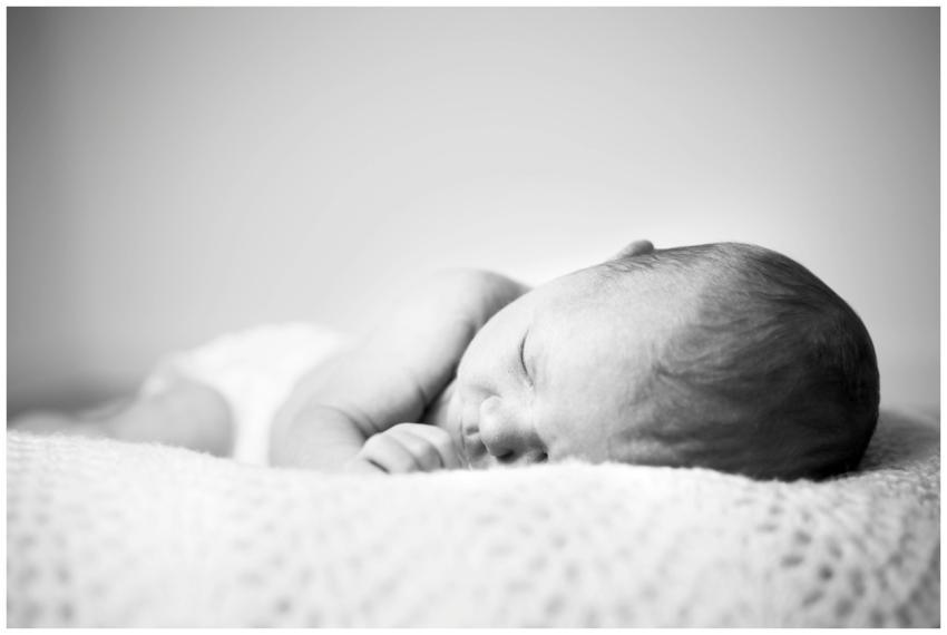 A serene black and white photo of a sleeping newbo