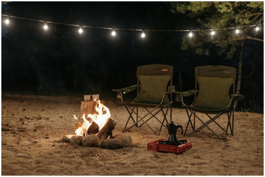 Outdoor camping scene with chairs and bonfire unde