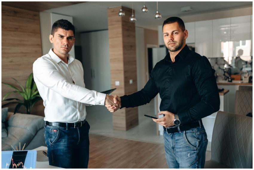 Two businessmen shaking hands in a modern office,