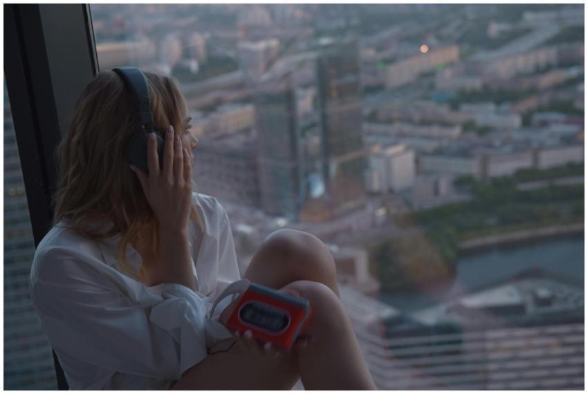 Caucasian woman listening to music on a cassette p