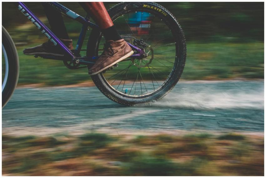 Close-up of a mountain biker speeding on a dusty t
