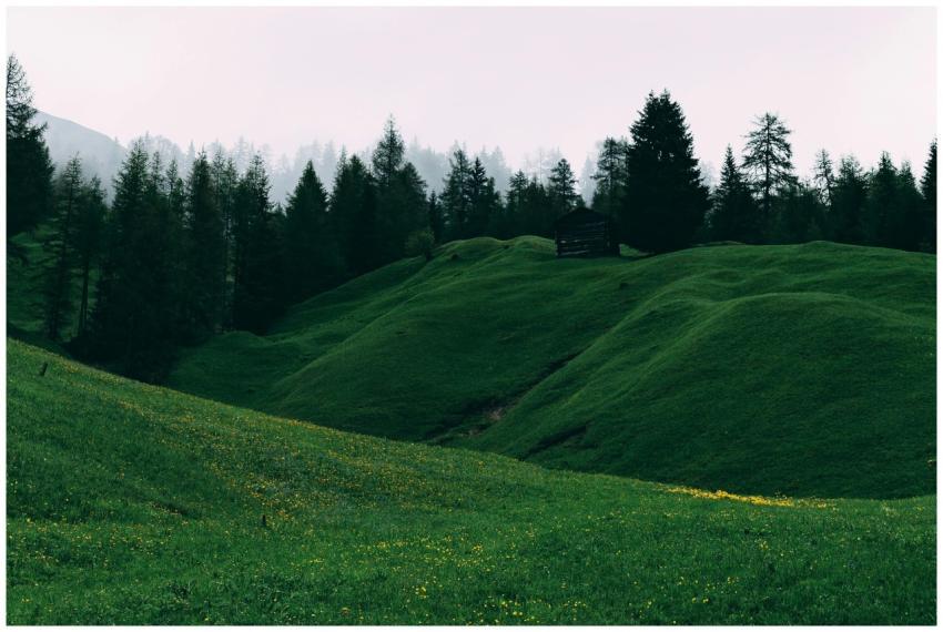 A serene landscape of vibrant green hills with a l