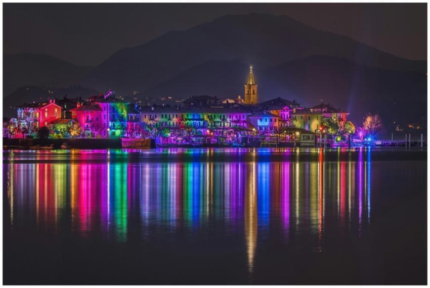 Bright colored lights reflecting on a tranquil lak