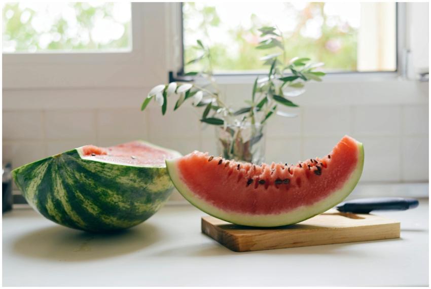A juicy slice of watermelon on a cutting board ind